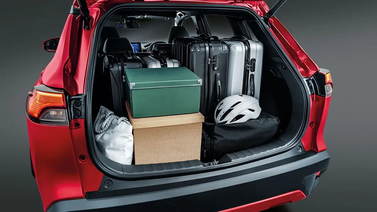 Toyota Corolla Cross 440L boot space showing generous cargo capacity with luggage, boxes and sports equipment
