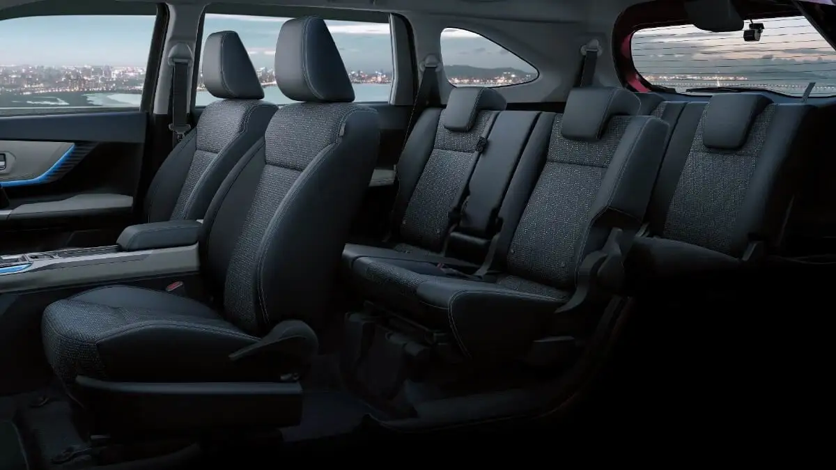 Toyota Veloz interior showing 7-seat configuration with multi-fold captain chairs and bench seating arrangement