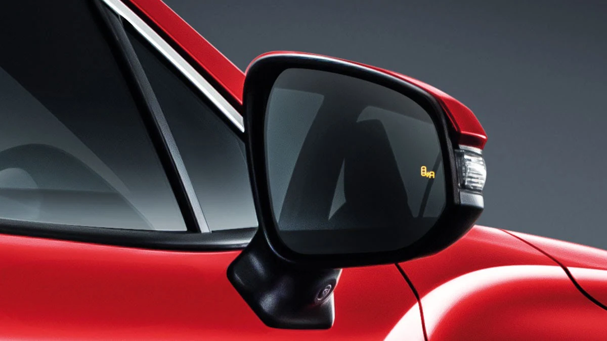 Toyota Corolla Cross side mirror with Blind Spot Monitor warning indicator showing BSM safety alert system activated
