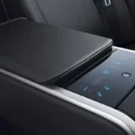 Luxury rear seat armrest with touchscreen controls and climate settings in premium sedan interior cabin