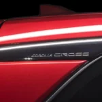 Toyota Corolla Cross side body panel detail showing red paint finish and Cross model nameplate lettering