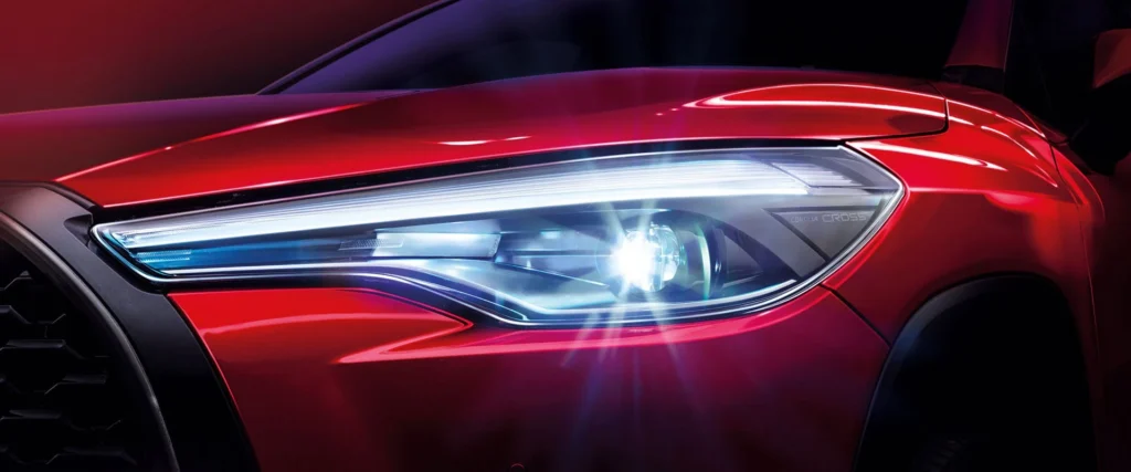 Toyota Corolla Cross LED headlight detail showing modern lighting technology with blue and white illumination