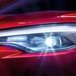 Toyota Corolla Cross LED headlight detail showing modern lighting technology with blue and white illumination