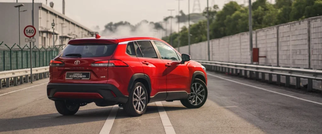 Toyota Corolla Cross positioned on elevated roadway showing dynamic stance and sporty design profile