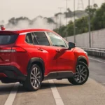 Toyota Corolla Cross positioned on elevated roadway showing dynamic stance and sporty design profile