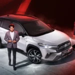 Toyota Corolla Cross GR Sport presentation with professional models in formal attire and dramatic red studio lighting
