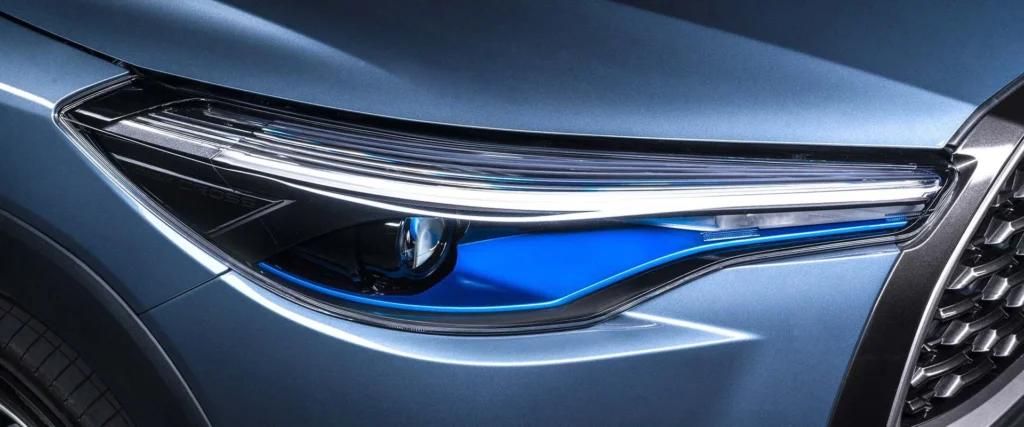 Close-up of Toyota Corolla Cross Hybrid Electric LED headlight featuring blue accent lighting and modern design