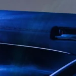 Interior door handle of Toyota Corolla Cross Hybrid Electric with illuminated accent lighting and premium interior trim