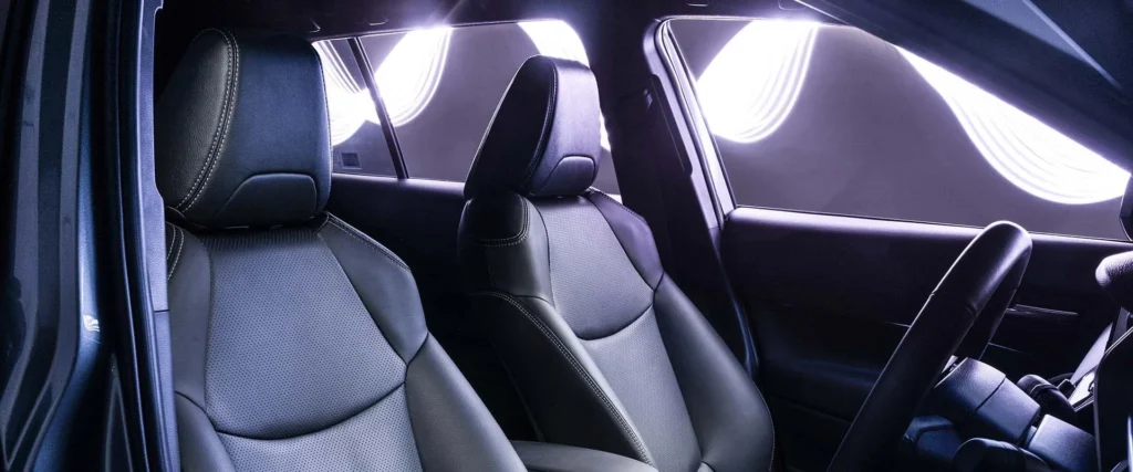 Toyota Corolla Cross Hybrid Electric front seats showing premium upholstery with natural sunlight streaming through windows