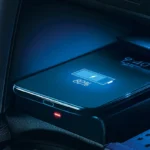 Toyota Corolla Cross wireless phone charging pad showing smartphone with battery indicator in center console