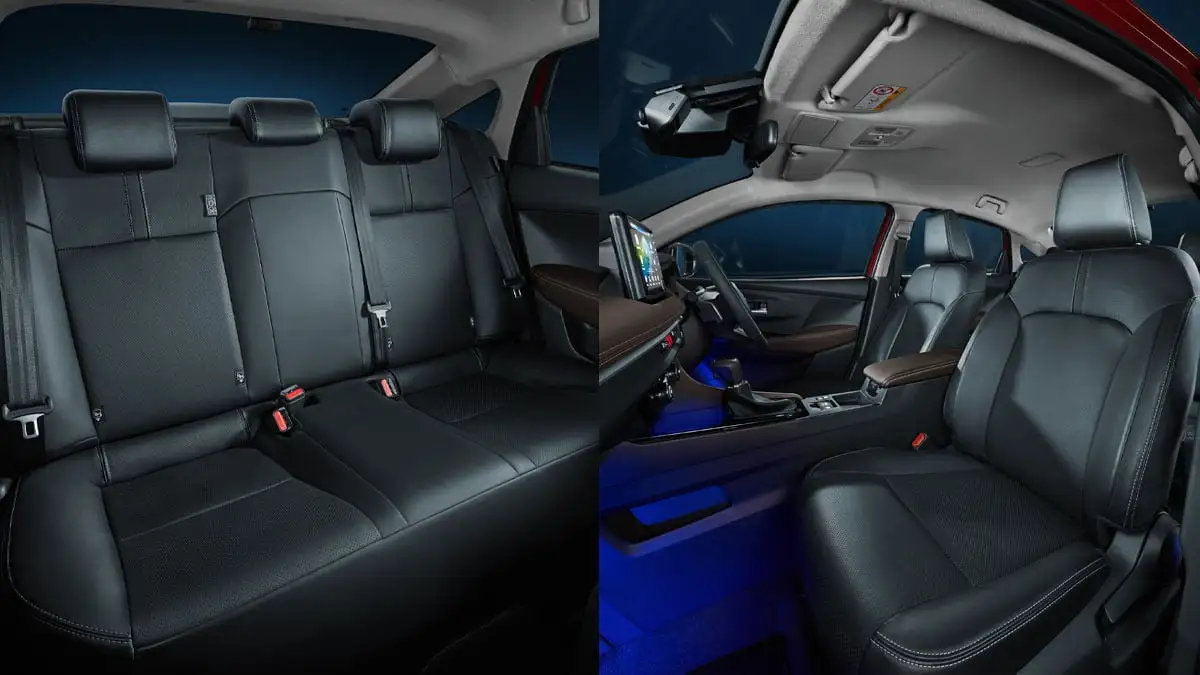 Toyota Vios interior showing ergonomic black leather seats in both front and rear with blue ambient lighting