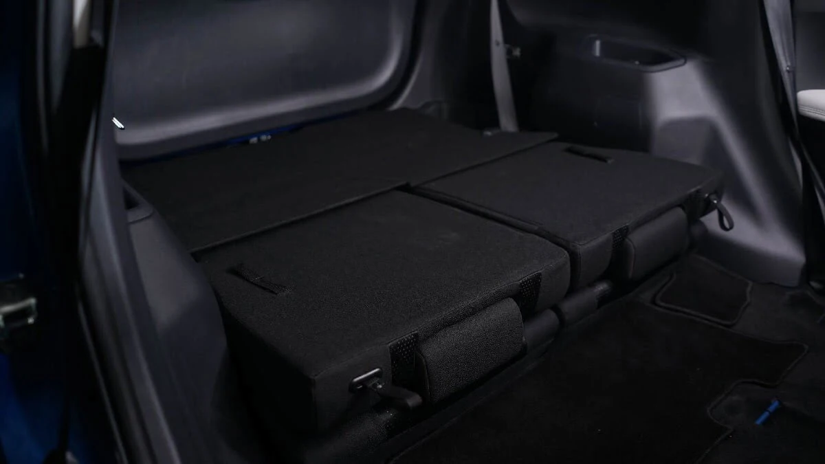 Toyota Veloz interior showing foldable rear seats in flat position creating expanded cargo space for storage