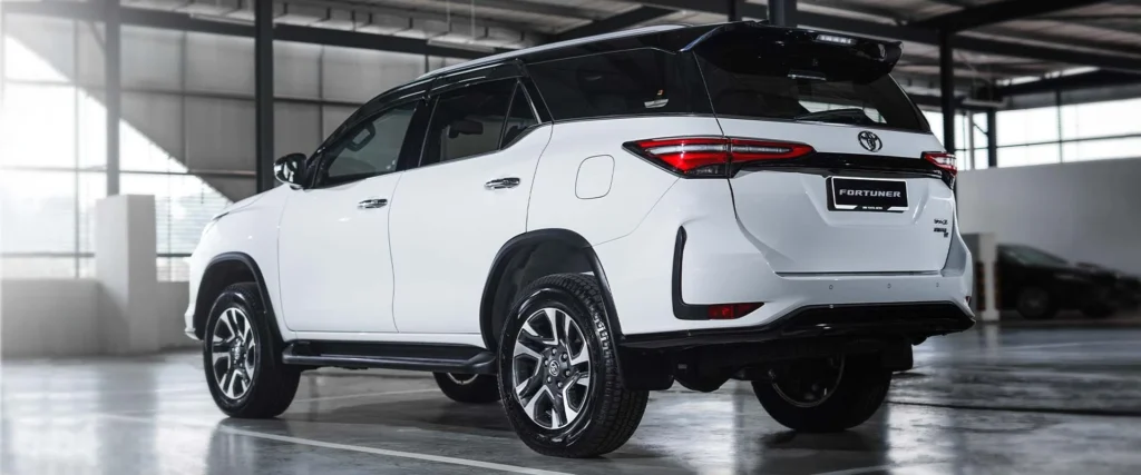 Toyota Fortuner SUV positioned in modern garage showing sleek profile and contemporary taillight design