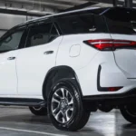 Toyota Fortuner SUV positioned in modern garage showing sleek profile and contemporary taillight design
