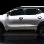 Toyota Fortuner positioned against dark background highlighting sleek body lines