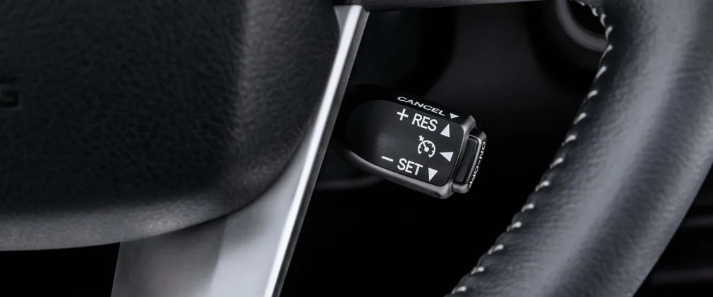 Close-up of Toyota Fortuner cruise control interface with ergonomic button layout and premium steering wheel design
