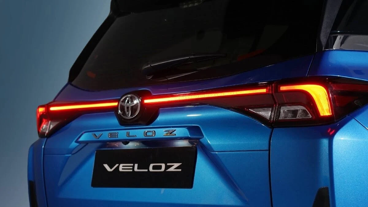 Blue Toyota Veloz back view detail featuring modern LED taillight design with illuminated light bar and badge