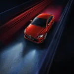 Red Toyota Vios sedan aerial top view with dynamic red light streaks creating motion effect background