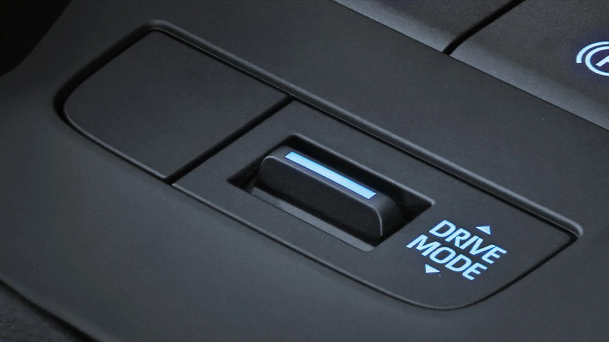Toyota Harrier center console featuring illuminated drive mode switch with blue LED indicator and toggle controls