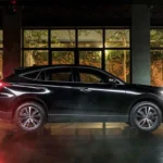 Black Toyota Harrier SUV positioned in contemporary glass showroom