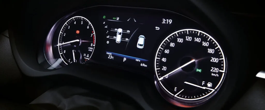 Toyota Harrier instrument cluster displaying speedometer, tachometer, and digital information screen with vehicle status