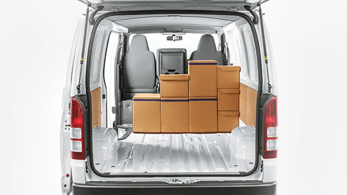 Toyota Hiace cargo area with open rear doors showing spacious interior loaded with brown delivery boxes