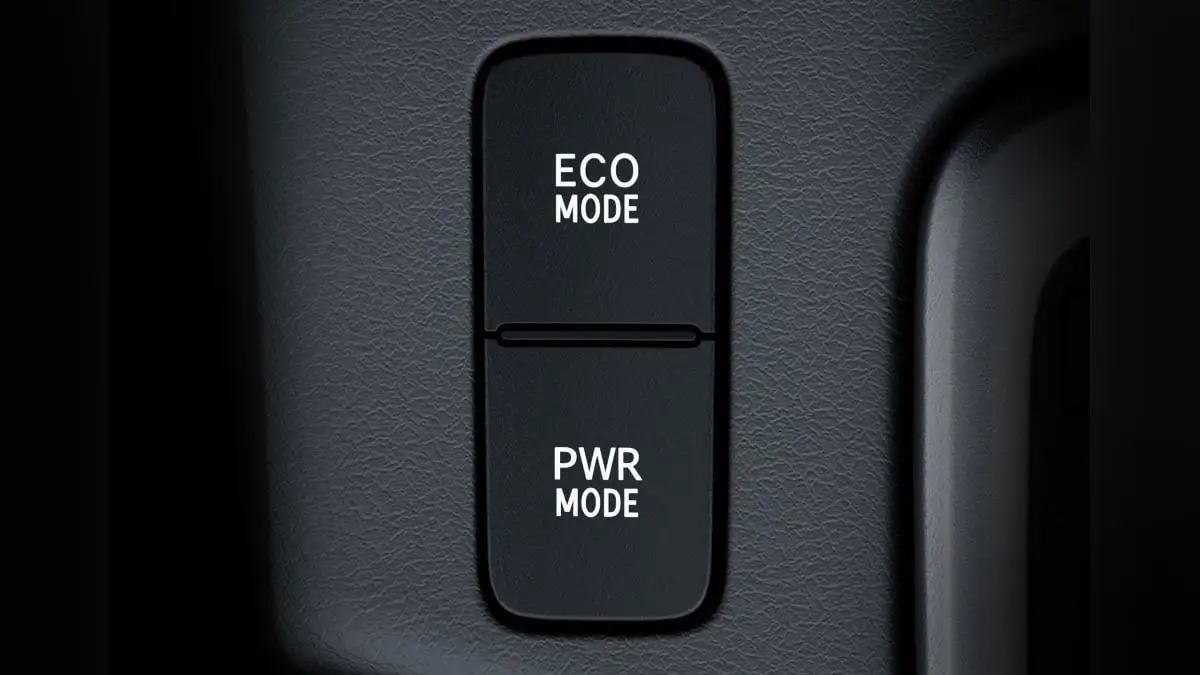 Toyota Hilux dashboard controls showing economy and power mode selection switches for fuel efficiency and driving dynamics