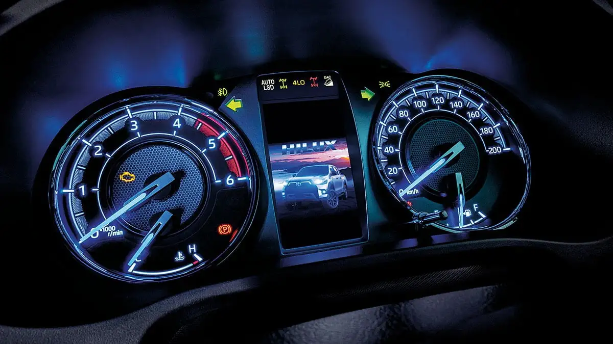 Toyota Hilux Optitron instrument cluster with digital MID display showing tachometer, speedometer, and vehicle information