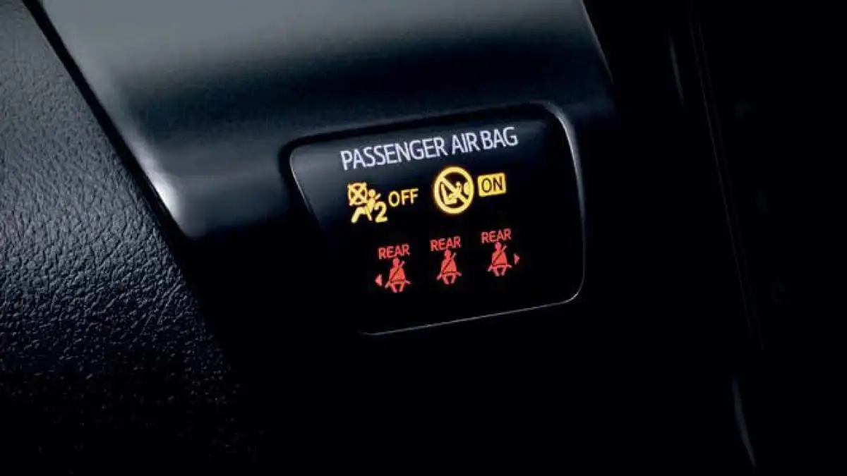 Toyota Hilux safety alert screen featuring seat belt reminder system with passenger airbag ON/OFF and rear occupant warnings