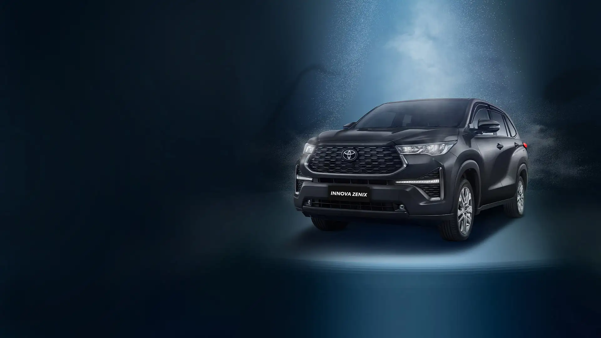 Toyota Innova Zenix with modern design featuring chrome grille and alloy wheels on dynamic blue background