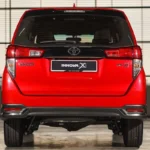 Rear view of red Toyota Innova showcasing tailgate design, brake lights, and modern proportions