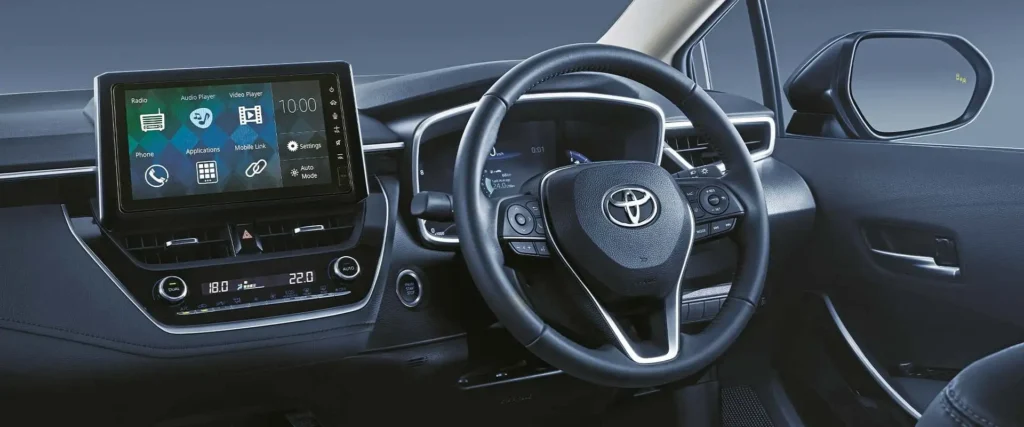 Toyota Corolla dashboard featuring touchscreen infotainment system with steering wheel controls and digital display