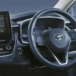 Toyota Corolla dashboard featuring touchscreen infotainment system with steering wheel controls and digital display