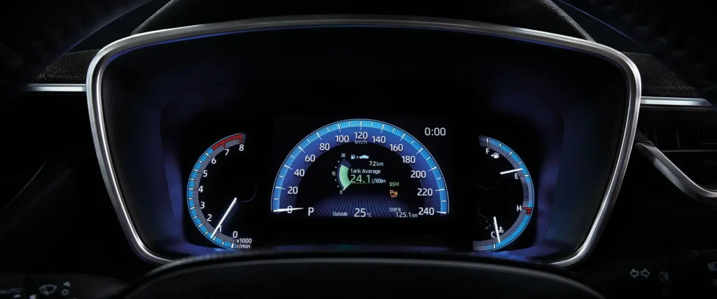 Modern Toyota Corolla dashboard showing tank average fuel consumption readout and trip computer information