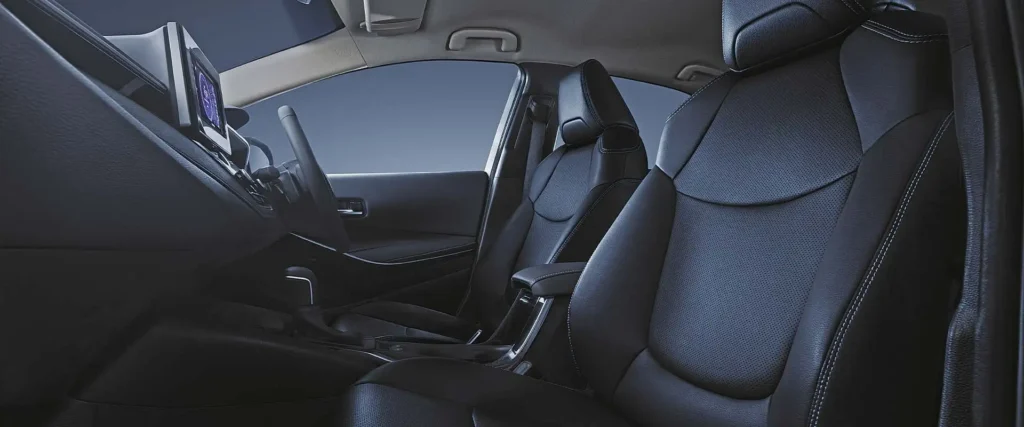Toyota Corolla interior cabin view showing black leather seats and spacious passenger compartment design