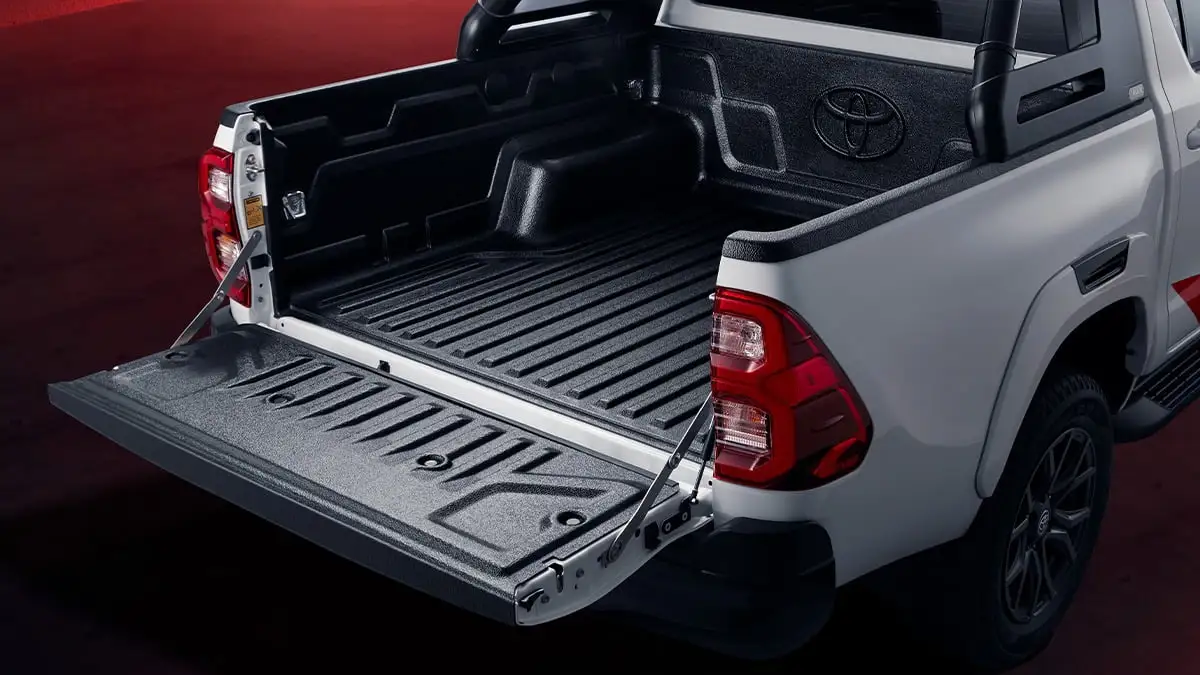 Toyota Hilux GR Sport truck bed featuring Toyota logo and practical load space with protective bed liner coating