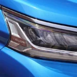 Toyota Veloz blue vehicle headlight macro view highlighting advanced lighting technology and styling elements