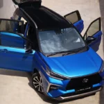 Toyota Veloz blue vehicle displayed with open doors and trunk showcasing interior space and accessibility