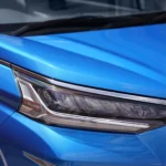Toyota Veloz blue vehicle headlight macro view highlighting advanced lighting technology and styling elements