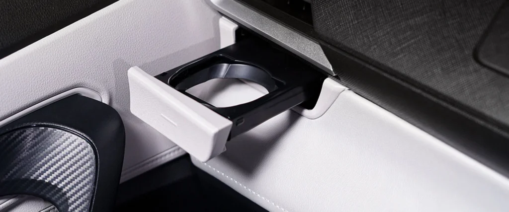 Car interior cup holder detail in Toyota Veloz showing practical storage solutions and modern design elements
