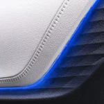 Toyota Veloz interior door panel detail with gray leather and blue accent trim plus chrome door handle