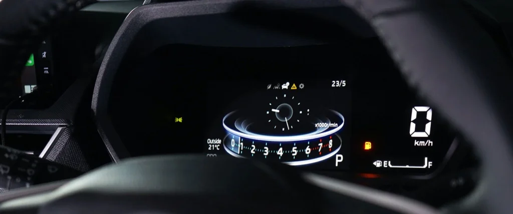 Toyota Veloz digital instrument cluster dashboard displaying speedometer, fuel gauge and warning indicators