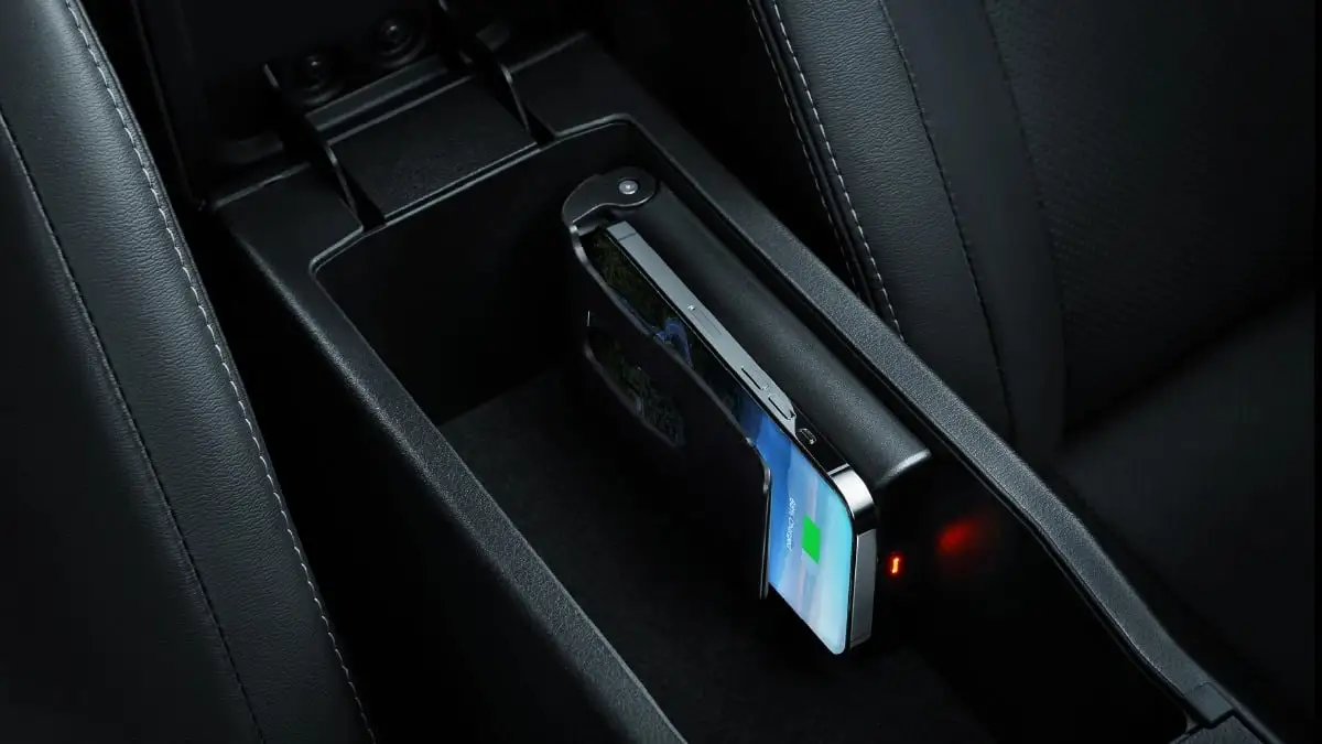 Toyota Vios interior featuring wireless charging pad with smartphone being placed for convenient device charging
