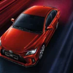 Toyota Vios red car overhead perspective showing roof design with dramatic lighting and speed effects
