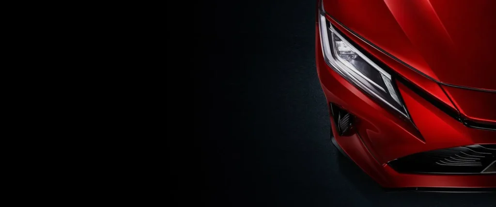 oyota Vios red car headlight close-up featuring modern LED lighting technology and sleek styling