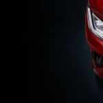 oyota Vios red car headlight close-up featuring modern LED lighting technology and sleek styling