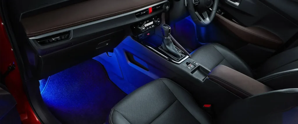 Car interior detail featuring Toyota Vios gear selector and console with atmospheric lighting effects