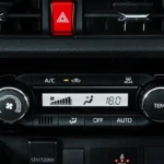 Car interior controls in Toyota Vios showing air conditioning panel and push-button engine starter