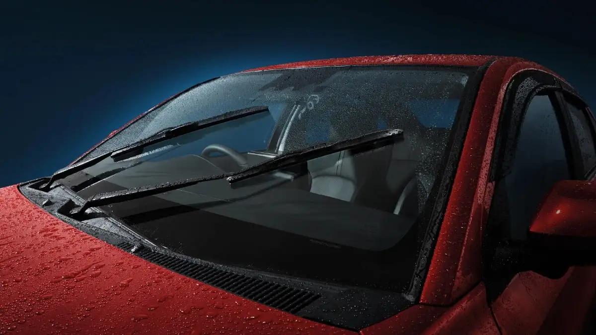 Red Toyota Vios featuring auto rain sensor technology with active windshield wipers clearing water droplets