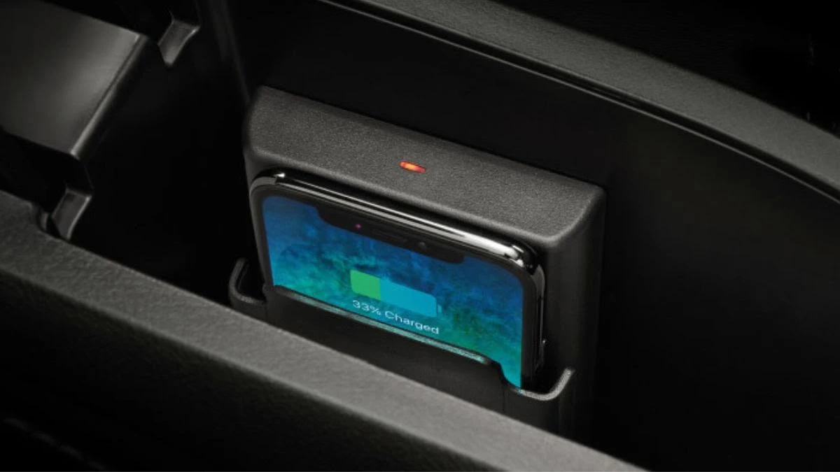 Toyota Yaris interior featuring wireless charging pad with smartphone being placed for convenient device charging
